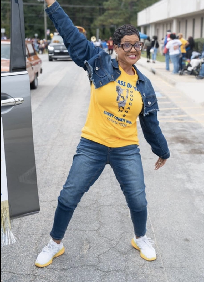 Dr. Lucretia celebrating at a community homecoming parade